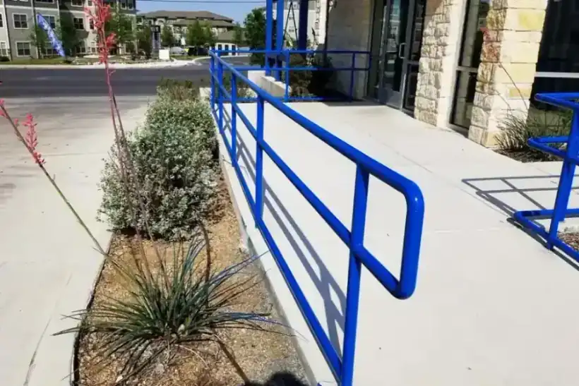 A blue steel handrail freshly coated with electrostatic paint